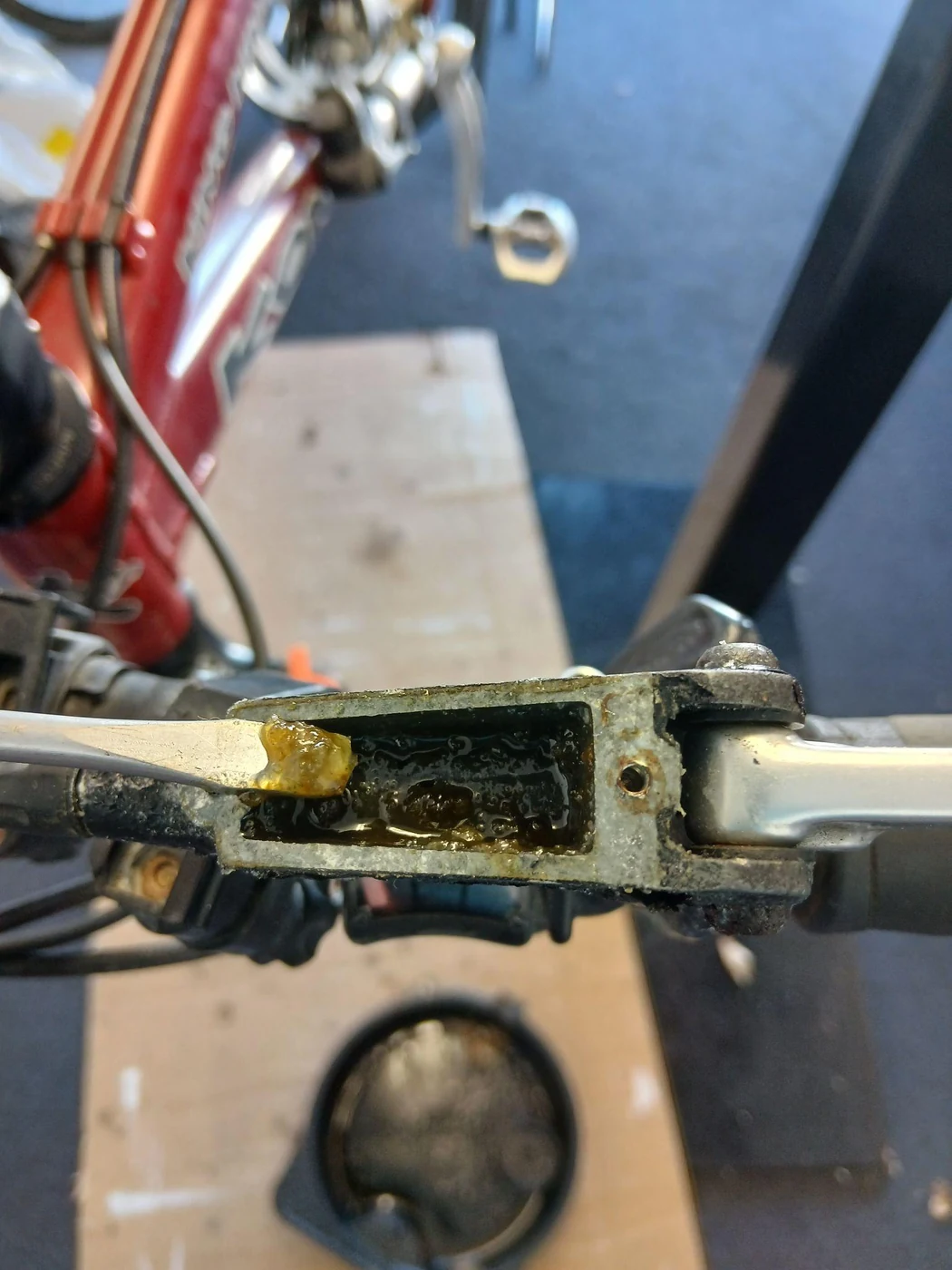 Thick, dirty old brake fluid inside an open brake lever reservoir